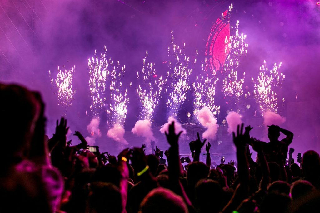 pexels-photo-1190298-1190298 Vibrant EDM concert scene with fireworks, smoke, and enthusiastic crowd enjoying the music.