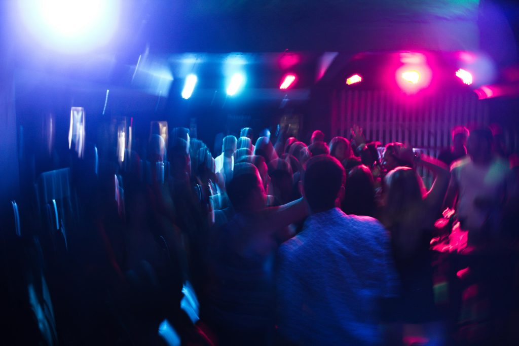 pexels-photo-801863-801863 Vibrant nightclub scene with blurred dancing crowd and colorful lights.